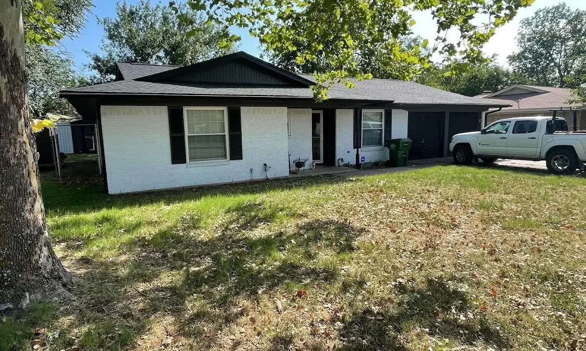 Professional roofing crew working on a residential roof in Alden